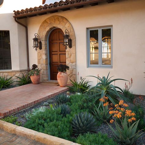 Are you dreaming of a beautiful Mediterranean-inspired front yard in Santa Barbara? Look no further! This article will provide you with 10 Mediterranean front yard design ideas from experienced and creative professionals in the Santa Barbara area. From vibrant alfresco dining spaces and vibrant outdoor spaces to cozy outdoor fire pits and lush gardens, each of these design ideas will help you bring your Mediterranean-inspired outdoor dreams to life. Mediterranean Front Yard, Front Yard Designs, Front Yard Design Ideas, Yard Design Ideas, Low Water Landscaping, Evergreen Landscape, Outdoor Fire Pits, Stucco Homes, Front Yard Design