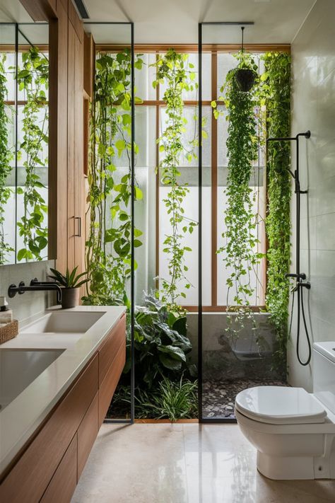 Create a serene, nature-inspired bathroom featuring climbing plants, warm wooden accents, and sleek modern fixtures. Large windows flood the space with natural light, blending indoor and outdoor vibes seamlessly. #NatureBathroom #BotanicalBathroom #BathroomDesign #ModernBathroom #NaturalLight #GreenBathroomDecor #IndoorOutdoorLiving #WoodAndPlants #BrightBathroomIdeas #RelaxingBathroomDesign Skylight Garden Indoor, Glass Shower With Plants, Bathroom With Big Window, Bathroom Nature Theme, Small Bathroom Plants, Plants In The Shower, Nature Bathroom Ideas, Biophilic Bathroom, Conservatory Bathroom