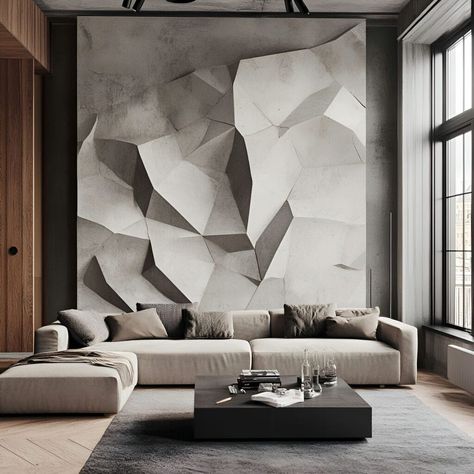 This sleek modern living room features a stunning geometric concrete accent wall with sharp, angular shapes, creating a bold, sculptural focal point. The minimalist design is complemented by a neutral-toned sectional sofa and a stylish black coffee table. Large windows flood the space with natural light, enhancing the industrial-chic aesthetic. Perfect for those seeking contemporary living spaces with unique concrete material building elements. Concrete Accent Wall, Compound Wall Designs, Textured Stone Wall, Art Wall Design, Minimalist Entryway, Rock Texture, Compound Wall Design, Inspiring Lifestyle, Stone Wall Design