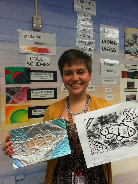 6th grade student with his art pieces; he holds the original printing plate turned into an aluminum foil relief sculpture and one ... Aluminum Tape Art, Aluminum Foil Printmaking, Aluminum Foil Sculpture, Print Making Elementary Art, Tin Foil Art Elementary, Foil Relief Art Lesson, Foil Sculptures For Kids, Radial Printmaking Lesson, Aluminum Foil Art