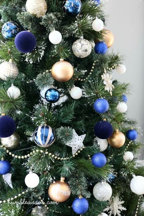 a bright Christmas tree with white, gold, blue and navu ornaments and white snowflakes is amazing and bold Gold And Ivory Christmas Tree, Ivory Christmas Tree, Green Christmas Tree Decorations, Blue Christmas Tree Decorations, Floral Christmas Tree, Blue Christmas Decor, Silver Christmas Decorations, Christmas Tree Decorating Themes, Blue Christmas Tree