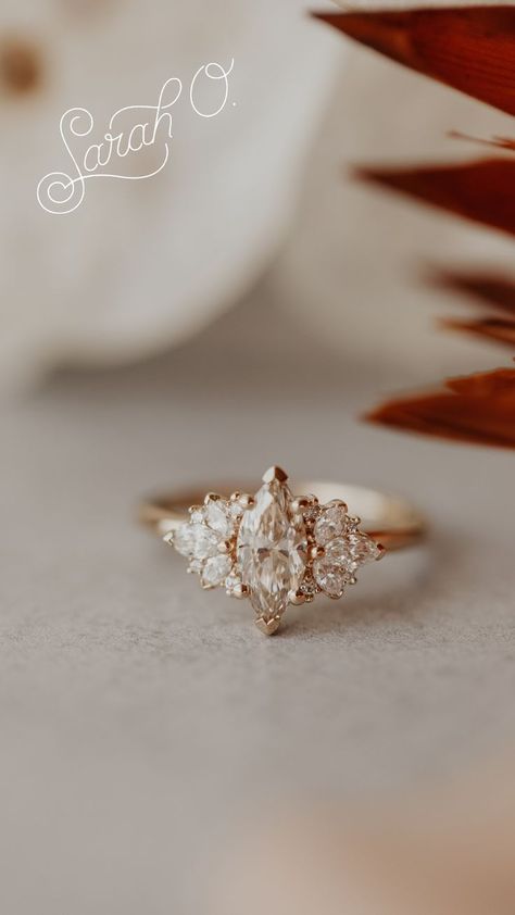 A marquise diamond center stone framed by round side diamonds. Available in yellow, white, and rose gold. Perfect for the vintage, boho, or classic bride. #diamondweddingring #weddingday #bohobride #vintagewedding #classicwedding Engagement Ring Boho, Marquise Engagement Ring, Classic Bride, Marquise Diamond Engagement Ring, Classic Brides, Marquise Ring, Engagement Rings Marquise, Dress Rings, Boho Bride