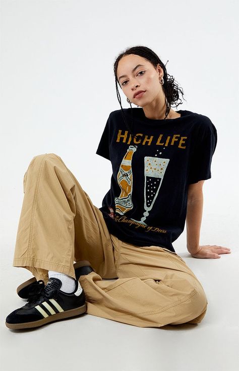 Step up your graphic tee rotation with the new Miller High Life T-Shirt from Junk Food. Crafted for both comfort and style, this tee effortlessly combines retro flair with a touch of casual coolness.Solid color teeShort sleevesCrew necklineFront graphicRelaxed fit100% cottonMachine washableModel is wearing a size smallModel measurements: 5’7.5” height, 32” bust, 23” waist, 35” hip Junk Food Womens Miller High Life T-Shirt - Black size XS Womens Tshirt Outfit, Casual Outfits Tshirt, Vintage Tee Outfit, Black Tshirt Outfit, Graphic Tshirt Outfit, Short Tshirt, Tee Shirt Outfit, Miller High Life, Graphic Tee Outfits