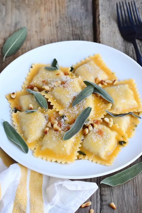 Indulge in the perfect comfort food with our delicious homemade butternut squash ravioli recipe. Our delicate pasta pockets are filled with a savory blend of roasted butternut squash, ricotta cheese, and aromatic herbs. Whether you're looking for a cozy dinner idea or wanting to impress your guests at a dinner party, this butternut squash ravioli dish is sure to be a hit. Butternut Squash Ravioli Filling Recipe, Butternut Squash Ricotta Ravioli, Roasted Butternut Squash Ravioli, Butternut Squash Ricotta Gnocchi, Homemade Butternut Squash Ravioli, Ravioli Dishes, Butternut Squash Ravioli Recipe, Squash Ravioli Recipe, Butternut Squash Ricotta