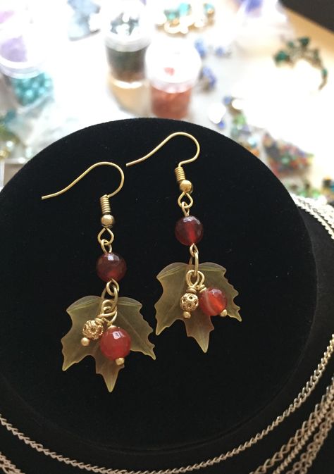 Lucite maple leaf earrings with gold filigree ball and carnelian crystal drops #diyearrings #falljewelry #mapleleaf Autumn Handmade Jewelry, Fall Inspired Jewelry, Fall Leaf Earrings, Thanksgiving Jewelry Diy, Autumn Earrings Diy, Fall Bead Jewelry, Maple Leaf Earrings, Fall Earrings Beaded, Fall Earring Ideas