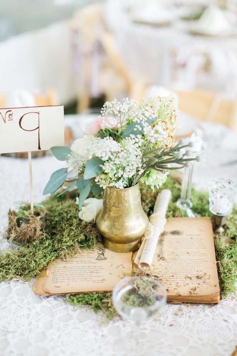 Vintage-Book Centerpiece With Gold Vase Vintage Book Centerpiece, Book Wedding Centerpieces, Moss Wedding, Book Centerpieces, Book Themed Wedding, Wedding Planner Book, Flowers And Greenery, Rustic Wedding Centerpieces, Vintage Inspired Wedding