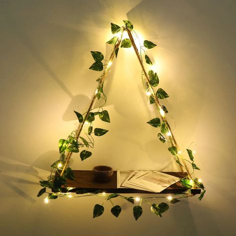 Display your favorite succulents plants, crystals, candles, pictures, books etc. Looks better in a set of 2. Package Includes: 1x Wall Hanging Shelf, Ivy vine, LED lights Size: H 19.7in (±50cm) / W 17in (43cm) Materials: Cotton rope, Natural wood, Plastic, Cooper Wire Fairy Lights And Plants Bedroom, Nature Room Ideas Bedroom, Unique Bedroom Ideas Creative, Fake Vines On Ceiling, Room Led Lights Ideas, Earthy Aesthetic Room, Room Ideas Floral, Cute Led Lights, Bookshelf With Plants