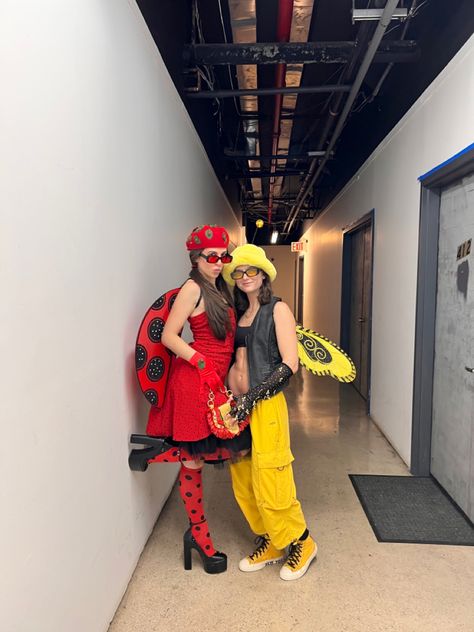 Two girls wearing Halloween costumes one girl is wearing a red polka dot dress red and black knee high polka dot socks black platform Steve Madden heels ladybug wings and a red kangol hat. Other girl is wearing yellow cargo pants yellow converse black bra black leather vest a yellow furry hat and bumble bee wings. Bumble Bee And Ladybug Costume, Easy Lesbian Couple Halloween Costumes, Couples Halloween Costume Ideas For Lesbians, Ladybug And Bee Costume, Halloween Costumes For Lesbian Couple, Lesbian Couple Costumes For Halloween, Couple Halloween Costumes For Lesbians, Girl Couple Costumes, Gay Halloween Costumes Women