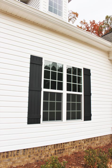 Black Board And Batten Shutters, White Windows With Black Shutters, Black Farmhouse Shutters Exterior, White Cottage Black Shutters, Shutters Exterior Black, Diy Black Shutters, Black House White Shutters, Modern Black Shutters, White House Black Shutters Farmhouse