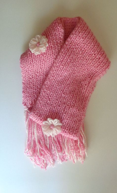 -Made with soft 100% acrylic yarn, this handknitted scarf is sure to keep any neck warm during cold weather. -With dimensions of 70" x 7", women will be encouraged to wear their scarf in any style they choose. -This scarf is adorned with three flowers in soft pink; one in the center, and two near the ends of the scarf. These flowers are also made from 100% acrylic yarn. -Tassels, the same colors as the scarf, measure about 8 inches long. Scarf With Tassels, Three Flowers, Cute Scarfs, Pink Scarf, Flower Scarf, Be Encouraged, Pink Scarves, Women Pink, Knitting Accessories