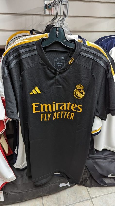 The Kitman - Football kit news from La Liga in Spain as leaked images of the new Real Madrid 2023-24 Adidas third shirt have appeared online. The leaked 2023-24 Real Madrid third shirt is predominantly black with dark grey Adidas stripes on the shoulders. Both the Adidas logo on the right breast and the Real Madrid crest on [...] The post Real Madrid 2023-24 Adidas Third Shirt Leaked appeared first on The Kitman - Old, Classic, Vintage & Retro Football Shirts & Football Kits. Real Madrid 3rd Kit, Real Madrid Crest, Real Madrid Shirt, Cristiano Ronaldo Manchester, Football Jersey Outfit, Chic Dress Classy, Retro Football Shirts, Soccer Outfits, Football Teams