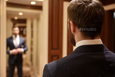 Man looking in mirror wearing suit by vadymvdrobot. Close up shot of back of bearded man wearing suit and looking at himself in mirror in wood dressing room#suit, #vadymvdrobot, #Close, #Man People Working Together, People Person, Meet Guys, Digital Tablet, Male Man, Business People, Black Business, 5 Things, Teamwork