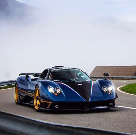 Pagani Zonda “Unica” in fully exposed Blue & Black carbon fiber w/ Tricolore central stripes and on the sides of the rear wing, Gold accent lines, Gold wheels. The car also features a Shark logo on the rear clamshell  Photo taken by: @qcpmonaco on Instagram   Owned by: @oleg_topcar on Instagram Honda Sports Car, Sports Cars Lamborghini, Car Throttle, Vintage Sports Cars, Aston Martin Vanquish, Pagani Zonda, Ferrari Laferrari, Lamborghini Veneno, Pagani Huayra