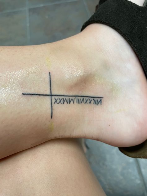 cross tattoo on ankle with the roman numerals for ; August 28, 2020 Cross With Birth Year Tattoo, Cross And Roman Numeral Tattoo, Cross With Roman Numerals Tattoo, Cross With Date Tattoo, Cross Tattoo On Ankle, St Christopher Tattoo, Side Foot Tattoos, Roman Numbers Tattoo, Tattoo On Ankle