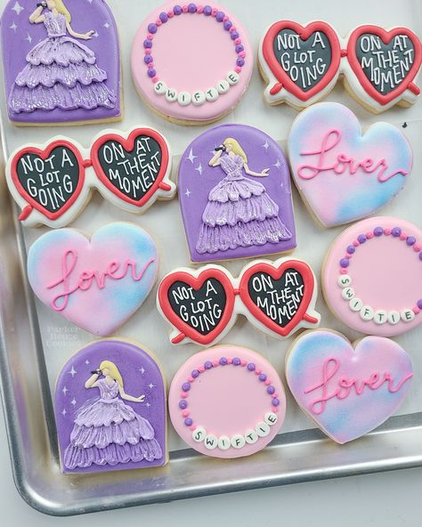 TS inspired cookies featuring friendship bracelets, lover hearts, red sunglasses, and the enchanted dress Lover Cookies Taylor Swift, Friendship Bracelet Cookies, Taylor Swift Birthday Cookies Decorated, Speak Now Cookies, Friendship Bracelet Cake, Eras Tour Cookies, Taylor Swift Birthday Cookies, Taylor Swift Cookies Decorated, Taylor Swift Sugar Cookies