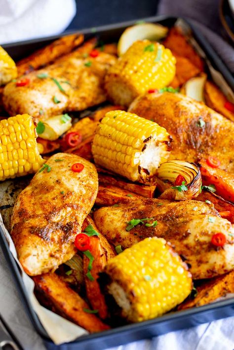 This Peri Peri Chicken Tray Bake is a healthy dinner idea that the whole family will love. Everything is cooked together on one sheet pan making it perfect for families who need easy meals! There's sweet potatoes, onions, corn, and juicy chicken breasts. All coated in a wonderful flavor-packed seasoning. You can make this spicy or mild to suit your family's tastes. A final wedge of lemon and some fresh cilantro/parsley and dinner is done! Peri Peri Chicken Tray Bake, Easy Tray Bakes Dinner, Tray Bake Dinner Recipes, One Tray Bake Dinners, One Tray Bake, One Tray Meals, Healthy Tray Bake Dinners, Tray Bake Recipes Dinner, One Pan Oven Dinners