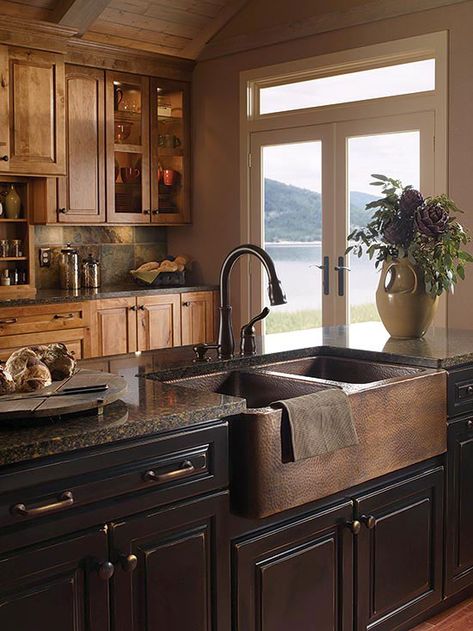 Who says you can't mix woods? This cozy, masculine kitchen goes all-in with both maple and walnut cabinetry and a deep, oak-front farmhouse sink. French doors provide just enough light to show off the room's varied textures – Affordable Rustic Kitchen, Plant Arrangement, Copper Kitchen Sink, Rustic Kitchen Cabinets, Decor Ikea, Rustic Kitchen Design, Farmhouse Kitchen Design, Design Blogs, Kitchen Farmhouse