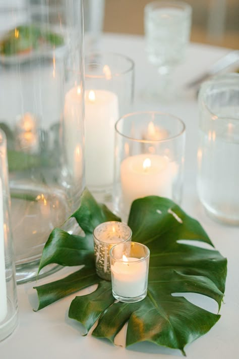 Tropical Candle Centerpieces Wedding, Tropical Diy Centerpieces, Elegant Tropical Party Decor, Tropical Leaves Centerpiece, Tropical Rehearsal Dinner Decorations, Tropical Engagement Party Ideas, Cheap Tropical Centerpieces, Tropical Leaf Centerpiece, Tropical Cocktail Table Decor