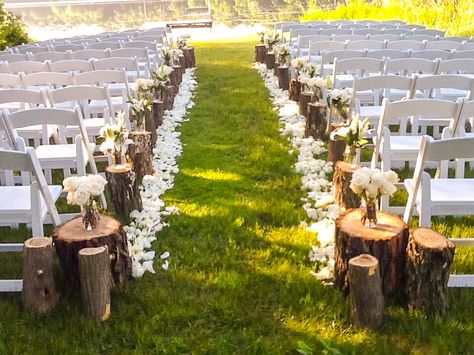 Tree Stumps Wedding Aisle, Stump Decorating Ideas Wedding, Fall Wedding Aisle Decorations Outdoor Tree Stumps, Wedding Arch With Tree Stumps, Rustic Outdoor Ceremony Decor, Diy Backyard Wedding Aisle, Beginning Of Isle Wedding Decor, Wood Stump Wedding Aisle, Mason Jar Isle Decorations