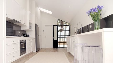 In this kitchen Dulux Whisper White was chosen to add warmth to this house, which does not receive much natural light. Dulux Vivid White, Dulux Whisper White, White Kitchen Wall Tiles, Perfect White Paint, Cork Decor, Dulux White, Dulux Paint Colours, White Wooden Floor, White Kitchen Paint