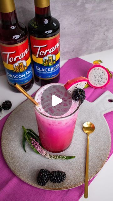 Katerina Diaz on Instagram: "Blackberry Dragon Fruit Refresher #ad  Run, don’t walk to your nearest @worldmarket to snag these two @torani syrups because this drink is about to become your new favorite🙌  This Blackberry Dragon Fruit Refresher is so deliciously fruity, and creamy. It will absolutely blow your mind, you have to try it!  * Frozen dragon fruit cubes * 1.5 tablespoons Torani Blackberry Syrup * 1.5 tablespoons Torani Dragon Fruit Syrup * Ice * 8 ounces lemonade * 4 ounces coconut milk * Fresh dragon fruit and blackberries for garnish   To a cup, add frozen dragon fruit, Torani Blackberry Syrup, Torani Dragon Fruit Syrup, ice, lemonade, and coconut milk. Stir to combine, then garnish with fresh dragon fruit and blackberries, and enjoy🤗  Let me know if you give this recipe a try Dragon Fruit Syrup Recipe, Dragonfruit Syrup, Dragon Fruit Acai Syrup Recipes, Dragon Fruit Recipe Starbucks, Dragon Fruit Simple Syrup, Blended Dragonfruit Starbucks, Fruit Syrup Recipe, Refreshing Fruit Drinks, Torani Syrup Recipes