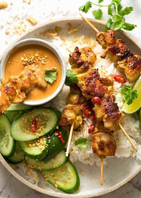 Overhead photo of Thai Chicken Satay with Thai Peanut Sauce on a plate with rice and cucumbers Chicken Satay With Peanut Sauce, Thai Chicken Satay, Chicken Satay Skewers, Thai Peanut Sauce, Thai Peanut, Recipetin Eats, Chicken Satay, Thai Chicken, Idee Pasto Sano