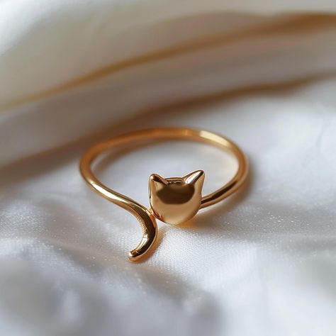 Embrace your love for feline elegance with YoPaCat's Cute Minimalist Golden Cat Ring. This charming ring features a sleek golden cat design, complete with a playful tail that wraps gracefully around your finger. Crafted with simplicity and style in mind, this piece is perfect for cat lovers who appreciate understated beauty. Whether you're dressing up for a special occasion or adding a touch... Ring Cat, Cat Rings, Cat Rings Jewelry, Crystal Bracelets Diy, Animal Rings Jewelry, Stylish Jewelry Accessories, Evil Eye Ring Gold, Jewelry Necklace Simple, Fancy Jewellery Designs