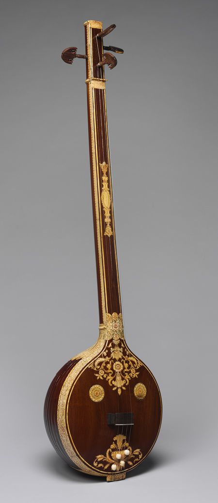 Tanjore tambura early 19th century, India (length 146.1 cm). Materials gourd, wood, metal, bone. This tambura is the larger in a set of two and referred to as the male. It is decorated with ivory inlay on a dark wood body. Its resonator is made from a single piece of wood, but carved to resemble bodies made of strips. Ancient Instruments, Indian Instruments, Art History Timeline, Indian Musical Instruments, Ancient Asia, Kids Musical Instruments, Indian Classical Music, Indian Music, Folk Instruments