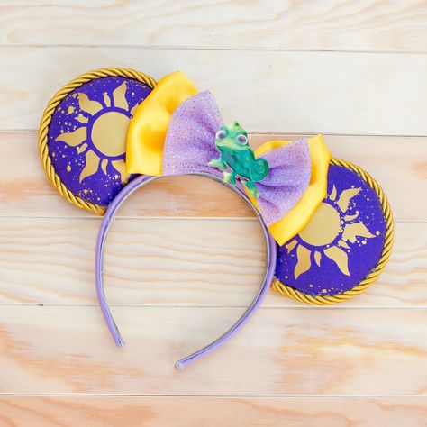 We hope you have the best day ever when you wear these ears! This tangled inspired design highlights the easily recognizable sun symbol that showed Rapunzel who she really was, and are perfect for Tangled fans far and wide.  The optional add-on pins of Pascal and Rapunzel's paintbrush make them complete, and allow you to customize your ears as you want! Each ear is approximately 4 inches in diameter, and stuffed to look extra cute and rounded. Headband is approximately 1 inch wide. All component Have The Best Day, Sun Symbol, Disney Etsy, Disney Photos, Disney Tangled, Disney Ears, Disney Diy, The Best Day, Mickey Ears