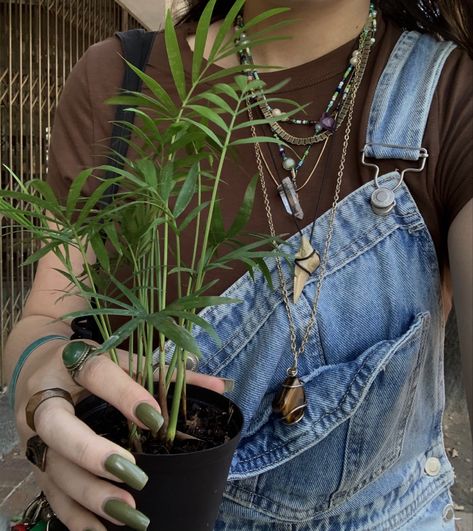 Girl holding a small parlor palm plant. Wearing denim overalls. Light green nails and lots of rings. Alice Fortescue, Rings Green, Aesthetic Outfit, Overalls, Ootd, Crystals