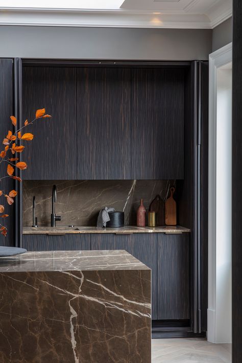 Continuing our #Autumnal theme with this stunning dark hued kitchen from @eggersmanndesign which uses a coffee brown marble for the countertops and backsplash with Maro Ebony composite wood for the cabinetry. #eggersmanndesign #kitchendesign #kitchendecor #luxurykitchen #luxurydecor #kitchenisland #bespokekitchen #kitcheninspo #interiordesign #interiordecor #luxuryhome #luxuryresidence #luxuryresidential #handcrafted #kitchendesign #dreamkitchen #darkkitchen Dark Wood Kitchen, Dark Brown Kitchen, Latest Kitchen Trends, Timber Kitchen, Dark Wood Kitchens, Dark Modern, Dark Kitchen, Brown Marble, Brown Kitchens