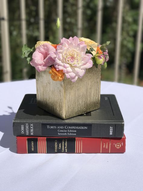 Law school graduation centerpieces - add the flowers to a stack of textbooks to incorporate the theme and provide some height to the centerpiece Law School Graduation Centerpieces, Law Centerpieces, Law School Graduation Party Centerpieces, Law Themed Party, Law School Graduation Party Ideas Lawyer, Graduation Party Ideas Law School, Law School Graduation Party Decorations, Law Graduation Party Ideas, Law School Graduation Party Ideas