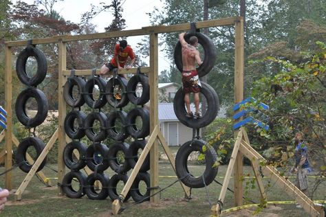 The DIY tire climbing wall. Made from junk yard tires, wood beams, and rope. Obstacle Course Ideas For Kids, Rope Playground, Playground Wood, Obstacle Course Ideas, Camping Games For Adults, Tire Playground, Diy Tire, Backyard Obstacle Course, Kids Obstacle Course