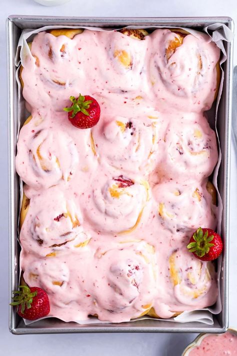 Fruity strawberry cinnamon rolls are a fun twist on the classic breakfast treat. Made with a quick and easy homemade jam filling and a pretty pink strawberry cream cheese icing. Strawberry Rolls Recipe, Strawberries And Cream Cinnamon Rolls, Strawberry Rolls With Cream Cheese Icing, Flavored Cinnamon Rolls Homemade, Valentines Cinnamon Rolls, Strawberry Cream Cheese Recipes, Pink Cinnamon Rolls, Strawberry Cream Cheese Icing, Strawberry Rolls