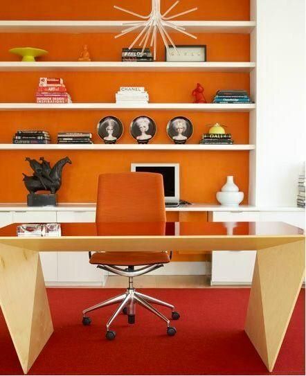 Orange home office with abstract shaped timber desk bright orange task chair and a full height bookcase wall with an orange back panel  and artfully arranged books and objects Orange Office, Orange Things, Orange Rooms, Beautiful Office, Orange Interior, Orange Decor, Orange House, Orange Walls, Orange Design