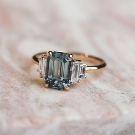 Grew & Co Fine Jewellery on Instagram: "Would you dare HEDY GREY SPINEL?​​​​​​​​ Such a mysterious and desirable colour...​​​​​​​​ An emerald cut Grey Spinel, framed by ascending pairs of matching baguette white diamonds. Set in 18ct Yellow Gold in a signature Grew & Co band.​​​​​​​​ .​​​​​​​​ .​​​​​​​​ .​​​​​​​​ .​​​​​​​​ .​​​​​​​​ .​​​​​​​​ . ​​​​​​​​ #grewandco #jewellery #spinel #greyspinel #diamond #diamondring #alternativebride #custom #bespoke #finejewellery #ring #rings #engagementring # Grey Spinel Engagement Ring, Spinel Engagement Ring, Grey Diamond Engagement Ring, Spinel Engagement Rings, Grey Moissanite, Gray Moissanite, Emerald Cut Diamond Engagement Ring, Wedding Diamond, Special Ring