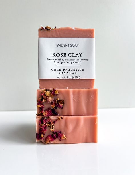 Indulge in the luxurious and rejuvenating experience of our All-Natural Cold Processed Soap, enriched with the delicate beauty of whole rose petal botanicals and the purifying benefits of rose clay. Scented with an exquisite blend of litsea cubeba, bergamot, rosemary, and juniper berry essential oils, this handcrafted soap offers a delightful and effective cleansing experience for your skin. Purifying and Nourishing Cleanse - Our soap features rose clay, a gentle and natural cleanser known for i Christmas Soap Ideas, Rose Clay Soap, Beeswax Soap, Soap Design Ideas, Soap Roses, Juniper Berry Essential Oil, Soap Business, Cold Processed Soap, Skincare Lifestyle