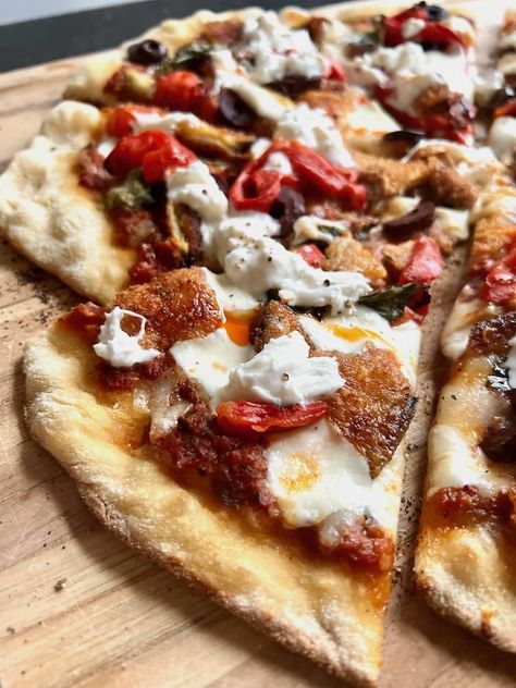 This Fried Eggplant Pizza recipe is like Eggplant Parm on steroids. Marinara, mozzarella, kalamata, roasted red peppers, burrata, and chili oil. Eggplant Pizza Recipe, Eggplant Pizza, Eggplant Pizzas, Fried Eggplant, Ceramic Grill, Eggplant Parm, Burrata Cheese, Pizza Stone, Chili Oil