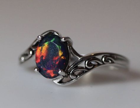 Natural black fire opal ring made with a AAA top quality grade 8x6mm oval faceted black fire opal gemstone, which is set into a beautiful vintage filigree style sterling silver setting with rhodium plating and lightly oxidized finish.The antiqued silver finish helps to highlight every detail of the Black Opal Engagement Ring, Fire Opal Engagement Ring, Opal Ring Vintage, Vintage Silver Jewelry, Black Opal Ring, Cute Engagement Rings, Opal Wedding Rings, Fire Opal Ring, Magical Jewelry