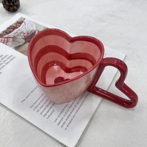 A gorgeous heart shaped hand painted cup. This rustic pink and red stripe mug is the perfect addition to your "cute cup collection," and will make a lovely coffee or herbal tea. The ceramic cutie is a good size, easy to hold with its heart shaped handle and is easy to care for being dishwasher safe. Product : Mug Quantity: 1 x Cup only Material: Ceramic Size: 300ml Easy to clean: Dishwasher safe Colours: Red., Light Pink We import this item from OUTSIDE of the U.K from a TRUSTED UK certified supplier. We have vetted all suppliers who are all making products to U.K regulations. In turn, we guarantee all purchases. This is a hand finished item please allow a small difference in size difference and allow for certain textural differences between batches. Heart Shape Cup, Heart Shaped Items, Cool Cup Designs, Cute Mug Handles, Heart Handle Mug, Painting Cups Ideas, Ceramics Mug Ideas, Ceramic Cup Ideas, Mug Shapes