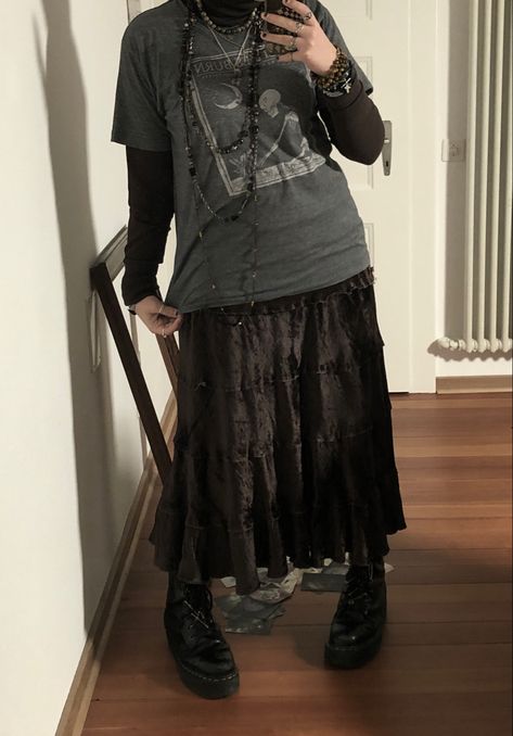 A mid-sized person/girl wearing a    grey graphic skeleton t-shirt, brown turtleneck, dark brown maxi skirt, platform dr. Martens and multiple dark green and gray crystal rings and bracelets. 		The person is also wearing multiple silver necklaces. Non Binary Winter Outfits, Midsize Grunge Fashion, Androgynous Goth Fashion, Whimsigoth Outfits Men, Plus Size Masc Fashion, Crowcore Fashion, Crowcore Outfit, Homestuck Outfits, Masc Goth