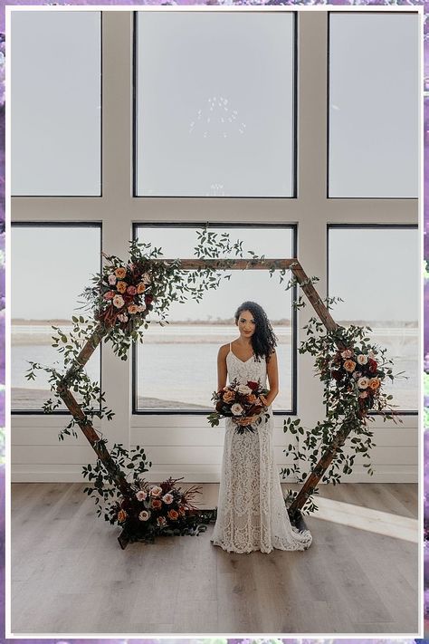 Discover stunning wedding arch ideas that will transform your ceremony into a dreamy celebration. From lush floral arrangements to elegant draping, these creative designs will enhance your special day and create the perfect backdrop for your vows. Whether you prefer a rustic charm or a modern aesthetic, our curated collection of wedding arch ideas will inspire you to craft a memorable experience that reflects your unique love story. Explore now for the perfect arch! Hexagon Wedding Arch Flowers Fall, Hexagon Wedding Arch Terracotta, November Wedding Arch, Terracotta Wedding Arch Decor, Wedding Ceremony Hexagon Arch, Octagon Wedding Arch Decor, Octagonal Wedding Arch, Hexagon Wedding Arch Flowers Diy, Octogan Wedding Arch