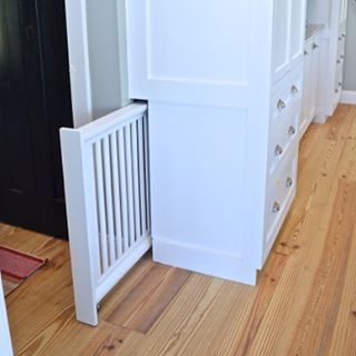 One of my favorite features in our new kitchen - a hidden doggie gate. (More about this practical addition on the blog today.) Storage Furniture Living Room, Baby Gate, Hidden Rooms, Dog Gate, House Stairs, Wood Doors Interior, Cool Apartments, Door Storage, Trendy Kitchen