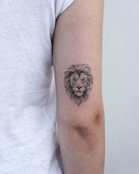 Lion head inked on the right triceps by Iris Tattoo Lioness Tattoo Design, Lion Tattoo Meaning, Small Lion Tattoo, Tattoo Placements, Iris Tattoo, Lioness Tattoo, Lion Head Tattoos, Couples Tattoo Designs, Leo Tattoos