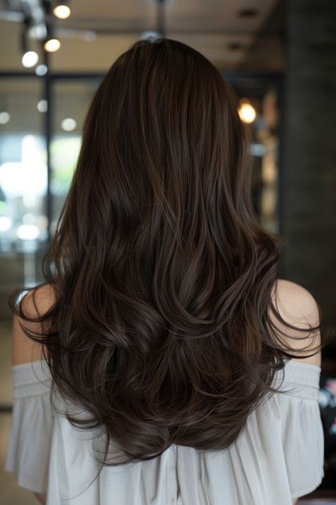 Long wavy brown hair cascading down the back of a person inside a modern, well-lit room. Solid Chocolate Brown Hair, Mocha Brunette Hair, Soft Brown Hair Color, Dark Mocha Brown Hair, Classy Hair Color Ideas, Solid Brown Hair Color, Classy Hair Color, Rich Dark Brown Hair Color, Dark Honey Brown Hair