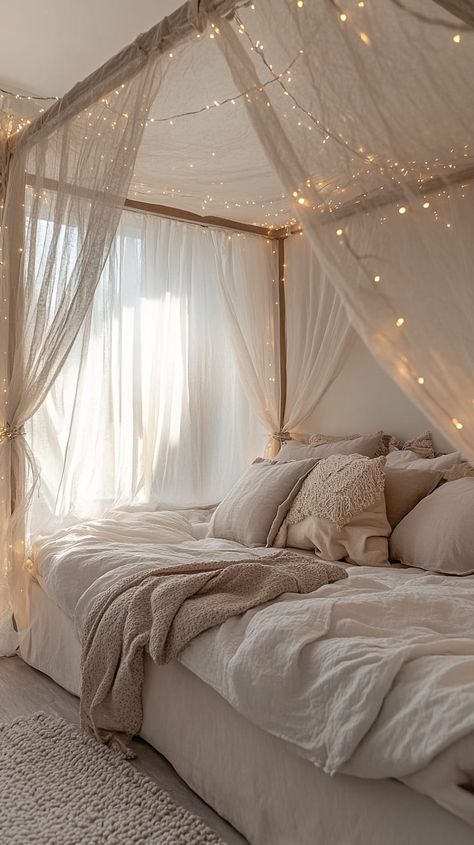 Cozy bedroom with a canopy bed, sheer curtains, fairy lights, and soft lighting in light gray, brown, and beige tones. Canopy Day Bed, Day Bed Canopy, Dreamy Bedrooms Romantic, Mountain Lodge Bedroom, Dream Room Ideas, Bed Canopy With Lights, Canopy Bed Drapes, Lodge Bedroom, Lavish Living Room