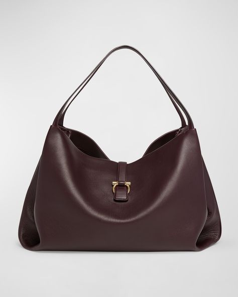 "Find SALVATORE FERRAGAMO Large Leather Tote Bag on Editorialist. Ferragamo tote bag in leather Shoulder straps Open top with center Gancini strap Interior, one zip pocket Approx. 9.4\"H x 15\"W x 8.7\"D Made in Italy" Timeless Designer Handbags, Luxury Leather Shoulder Bag, Ferragamo Bag, Fall Bags, Large Leather Tote Bag, Bag Interior, Designer Tote Bags, Large Leather Tote, Pretty Bags