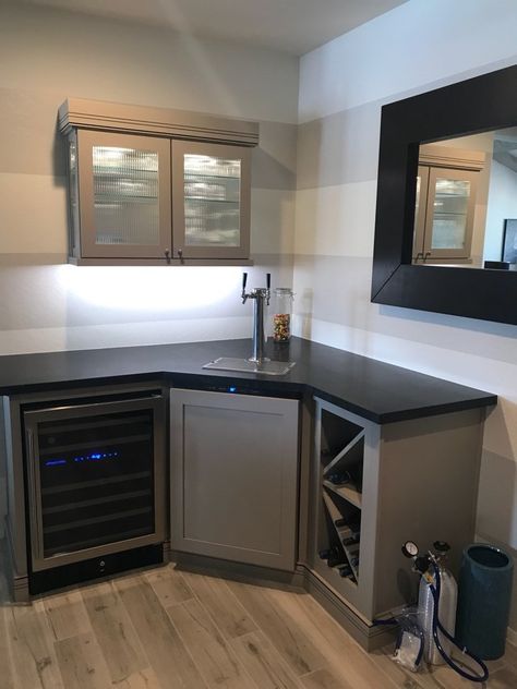 This dry bar build out with a kegerator features Wellborn Premier Series Cabinetry topped off with a black granite for a modern finish. When you are ready to #remodel, give TWD a call at (623) 544-1211 or visit us online at www.twdaz.com. #twdaz Cheap Diy Dry Bar, Kegerator Cabinet Built Ins, Kegerator Bar Ideas Diy, Corner Bar In Basement, Diy Home Dry Bar, Corner Dry Bar Ideas Basement, Home Bar Kegerator, Basement Kegerator Bar, Basement Bar With Kegerator