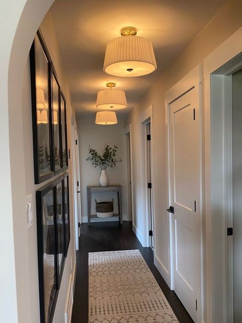 Kitchen Entry Wall Decor, Light Over Gallery Wall, End Of Long Hallway Ideas, Hallway With Lights, Pendant Lights In Hallway, Short Hallway Decorating, Apartment Lighting Design, Earthy Hallway Ideas, Wall Decor Hallway Narrow