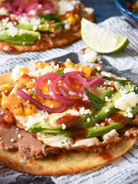 Tostadas with fied eggs and many toppings. Fried Egg Tostada, Egg Tostada, Easy Huevos Rancheros, Breakfast Tostada, Breakfast Tostadas, Texas Recipes, Best Egg Recipes, Fried Tortillas, Perfect Eggs